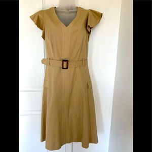 Casual woman’s dress with ruffled shoulders, knee length with belt